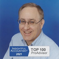 Photograph of Keith Gormezano, famous Advanced Certified QuickBooks ProAdvisor and QuickBooks Consultant, Trainer, Tutor, Instructor, Coach, or Teacher for new businesses and start ups in Seattle, Washington State who offers personalized, in person, one-on-one help, support, classes and training or clean up or set up assistance at your place, his, a quiet coffee shop, library, or other place with secure WiFi, or online using the phone and/or Instant Messenging (IM) wearing a pale blue button down business formal Nordstrom's shirt made of soft 100% cotton, short slightly receding light brown hair with a touch of gray showing his wisdom, blue eyes, trendy horizontal glasses with TransitionsB. photochromic lenses and flexible titaniam frames from Greenwood Optical, two behind the ear (BTE) CantuB 780D hearing aids from The Hear Center since replaced by two Phonak Savia Arts with Bluetooth receivers from the Veteran's Administration for free for his service so he can use them with his new cell phone with the company's SmartLink BlueTooth bridge and directional microphone device in noisy settings, and his always present smile and patience.